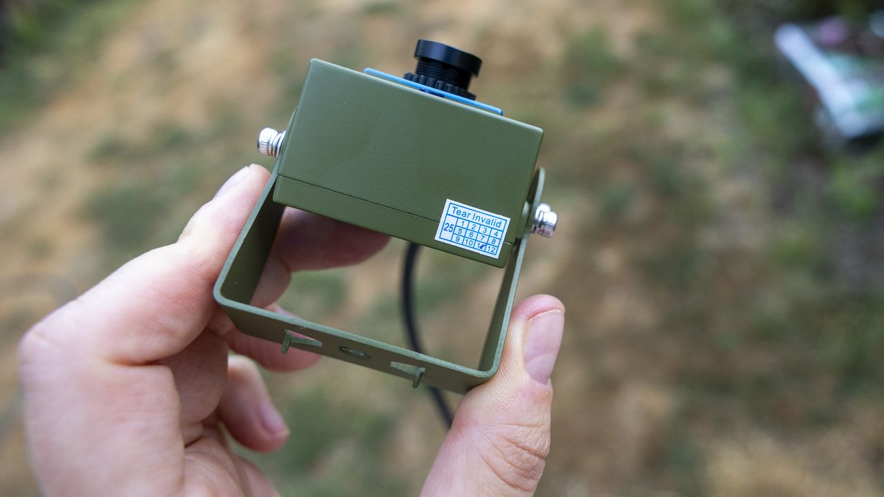 Close up of the Green Feathers TV connectable wildlife camera held in a female hand
