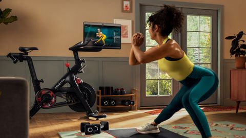 a photo of a woman exercising with the Peloton Bike Plus