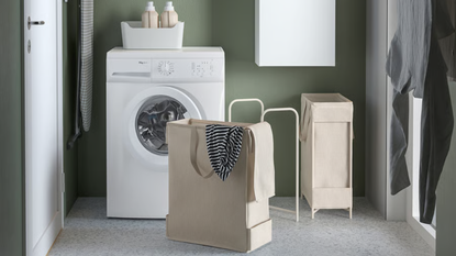 a laundry room with a white washer machine and a tan laundry basket