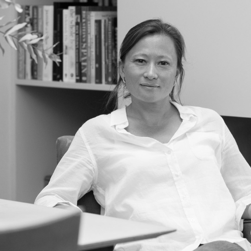 Black and white image of a woman in a white blouse.