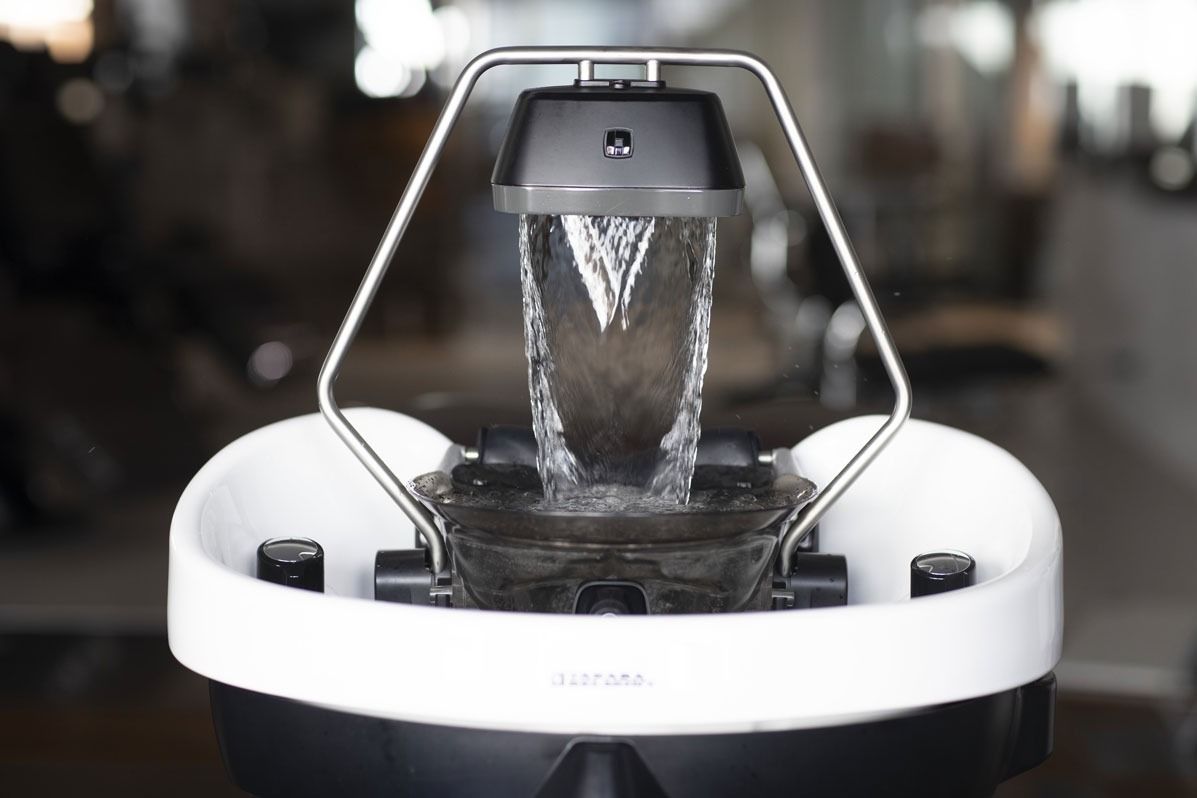 water pouring from hair washing fixture in spa