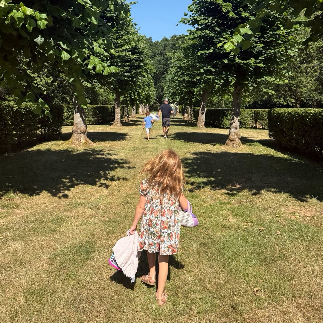 Princess Lilibet, Prince Archie and Prince Harry walking through grass at Althorp