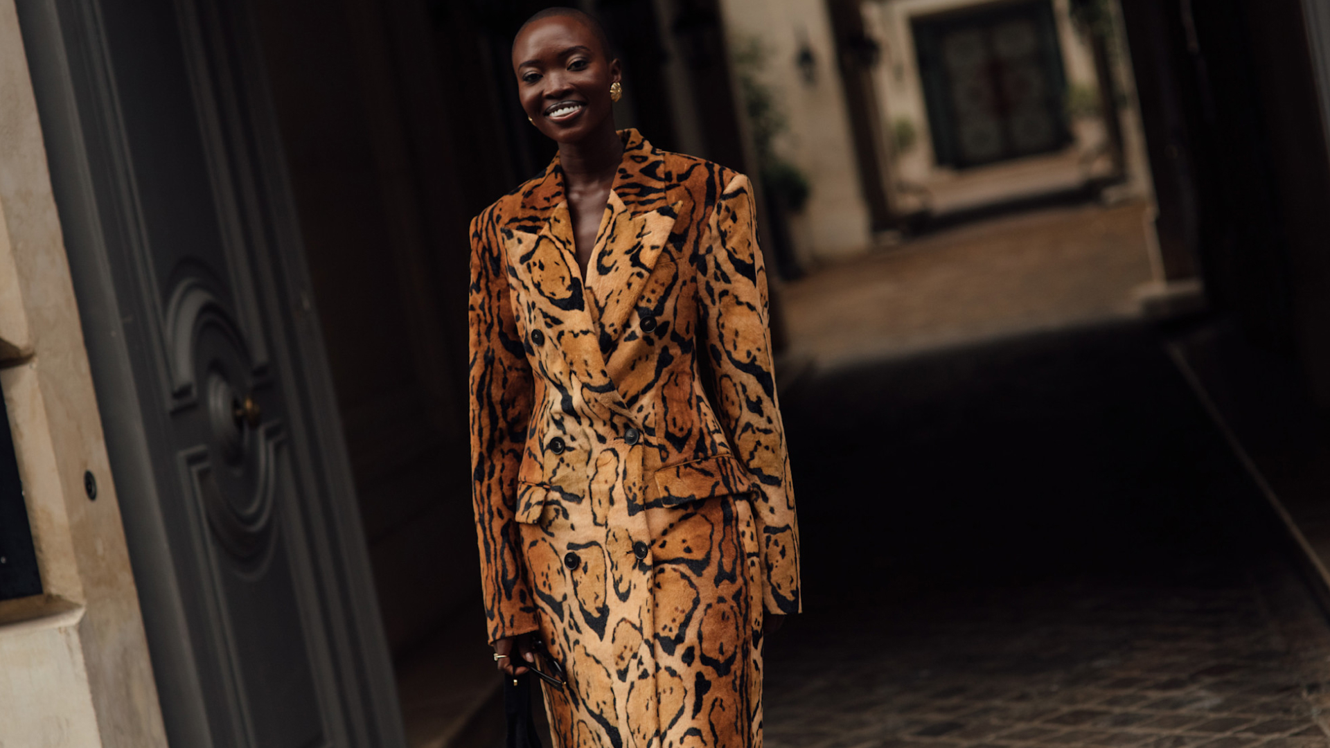 Woman wearing animal print jacket and skirt set