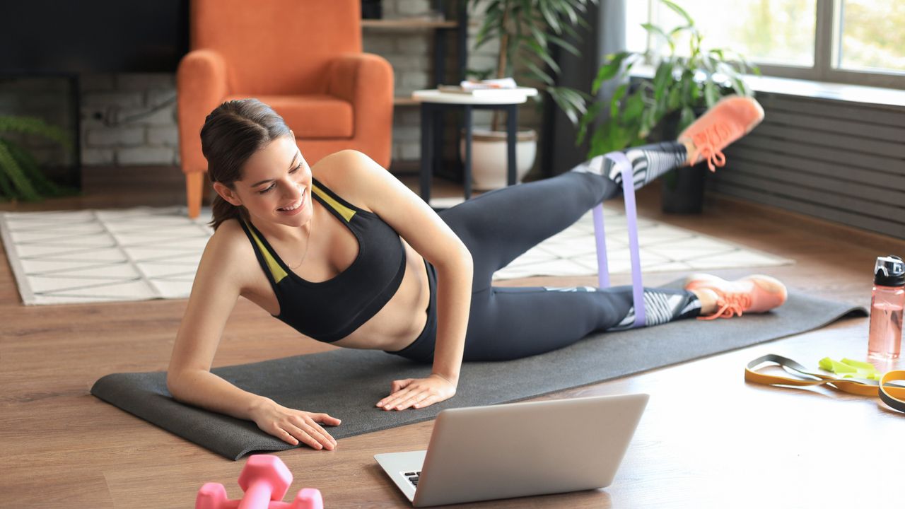 Woman doing floor-based exercise with resistance band