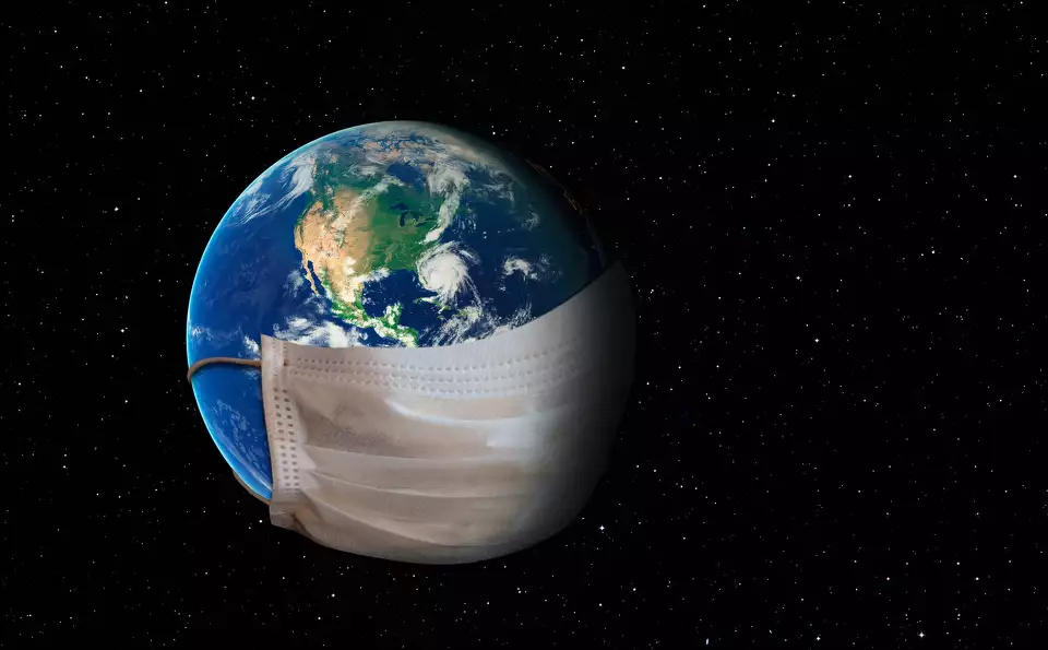 the earth hangs in space with a giant medical facemask draped across its lower half.