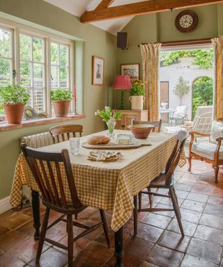 Dining room with a vaulted ceiling, french doors leading to courtyard and a farmhouse table