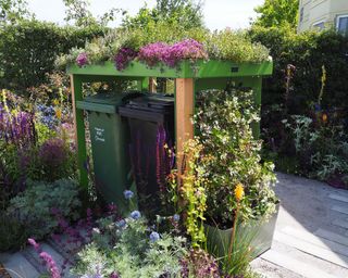 bespoke wheelie bin storage with green roof in pretty front garden