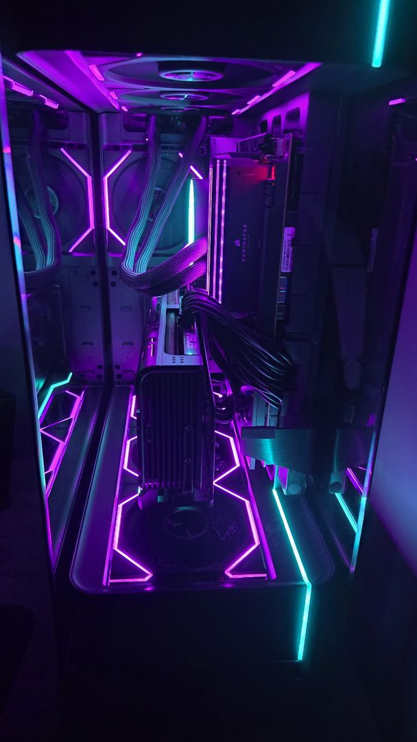 A gaming PC lit up with neon-style lighting and using an RX 9070 XT graphics card.