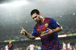 Lionel Messi celebrates one of his goals for Barcelona against Atletico Madrid in September 2011.