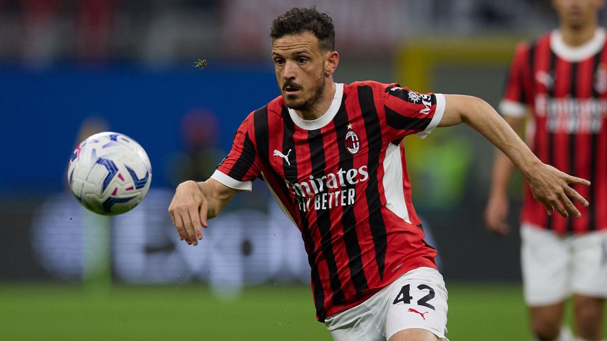 Alessandro Florenzi of AC Milan chases the football in the Milan black and red striped home shirt.