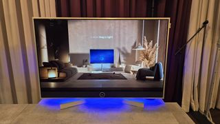 Loewe Stellar TV with a living room arrangement on screen