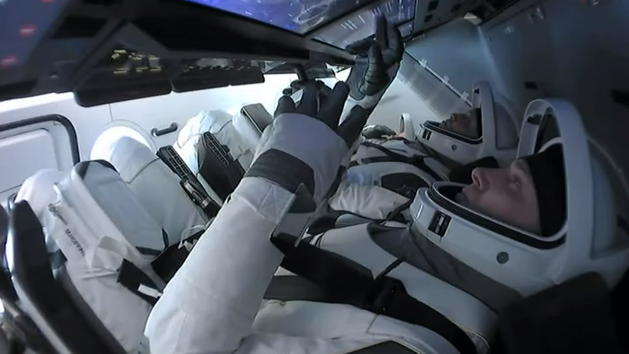 NASA astronauts Mike Hopkins (front) and Victor Glover (back) are pictured in the Crew Dragon Resilience as the Crew-1 mission returns to Earth, on May 2, 2021.