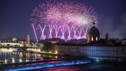 Fireworks light up the sky over the Garonne river as part of the annual Bastille Day celebrations in Toulouse, France