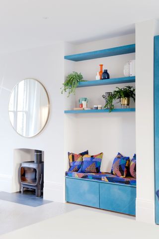 Blue storage bench built into a small living room alcove