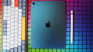 Blue iPad (2022) laying screen side down with Apple Pencil