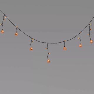 Jack-O-Lantern Icicle Mini String Lights against a gray background.