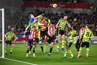 Aaron Ramsdale of Arsenal punches clea during the Premier League match between Brentford FC and Arsenal FC at Gtech Community Stadium on November 25, 2023 in Brentford, England.