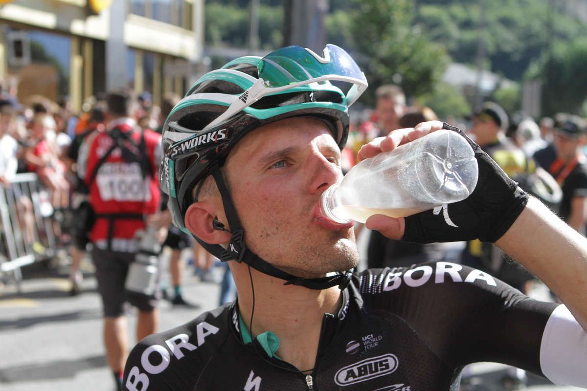 Rafa Majka chugs down his post-stage drink