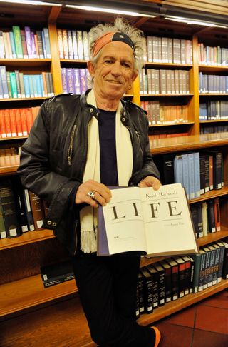 Still life, Richards poses with his autobiography at The New York Public Library, 2010