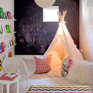 playroom with tent and blackboard wall