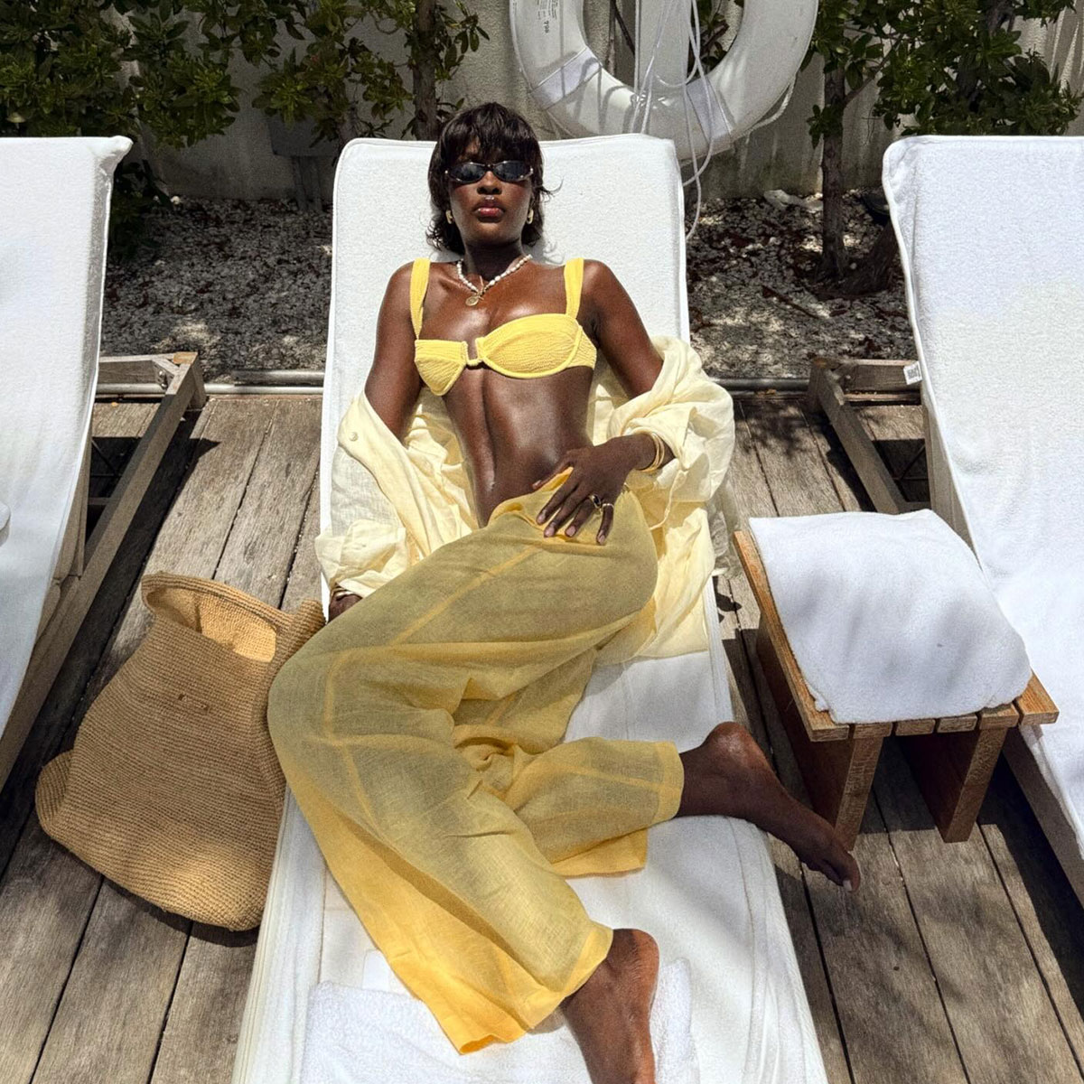 @lefevrediary lounging in pool chair in Monday Swim brand yellow bikini and pants set