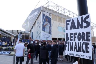 A Fan sign is seen reading "Fans before finance, All fans aren't we" as a protest against the European Super League outside the stadium prior to the Premier League match between Leeds United and Liverpool at Elland Road on April 19, 2021 in Leeds, England. Sporting stadiums around the UK remain under strict restrictions due to the Coronavirus Pandemic as Government social distancing laws prohibit fans inside venues resulting in games being played behind closed doors.