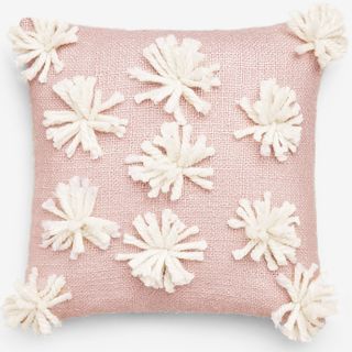 pink cushion with pom pom