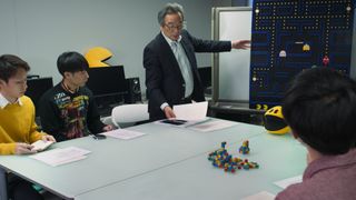 A still from High Score showing a meeting about Pac-Man
