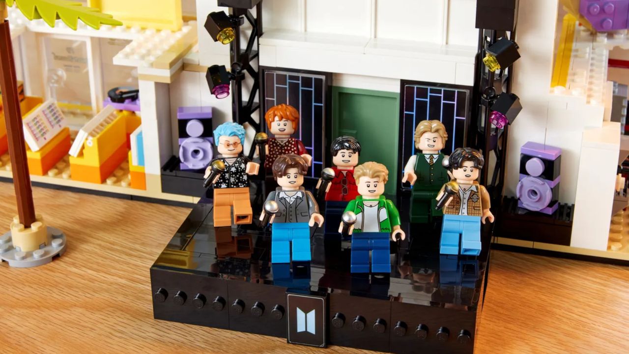 Lego BTS Dynamite sets with the Disco building in the background and Minifigs of the full band
