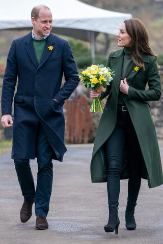 Prince William and Kate Middleton - who is wearing a green coat, jeans and black ankle boots visit the World Heritage Site visitor centre to learn more about the history of Blaenavon and the importance of the Ambassador programme on March 1, 2022 in Pontypool, Wales.
