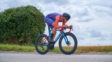 George Fox riding in an aero position on a road bike