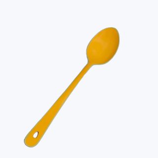 bright yellow mixing spoon on a white background