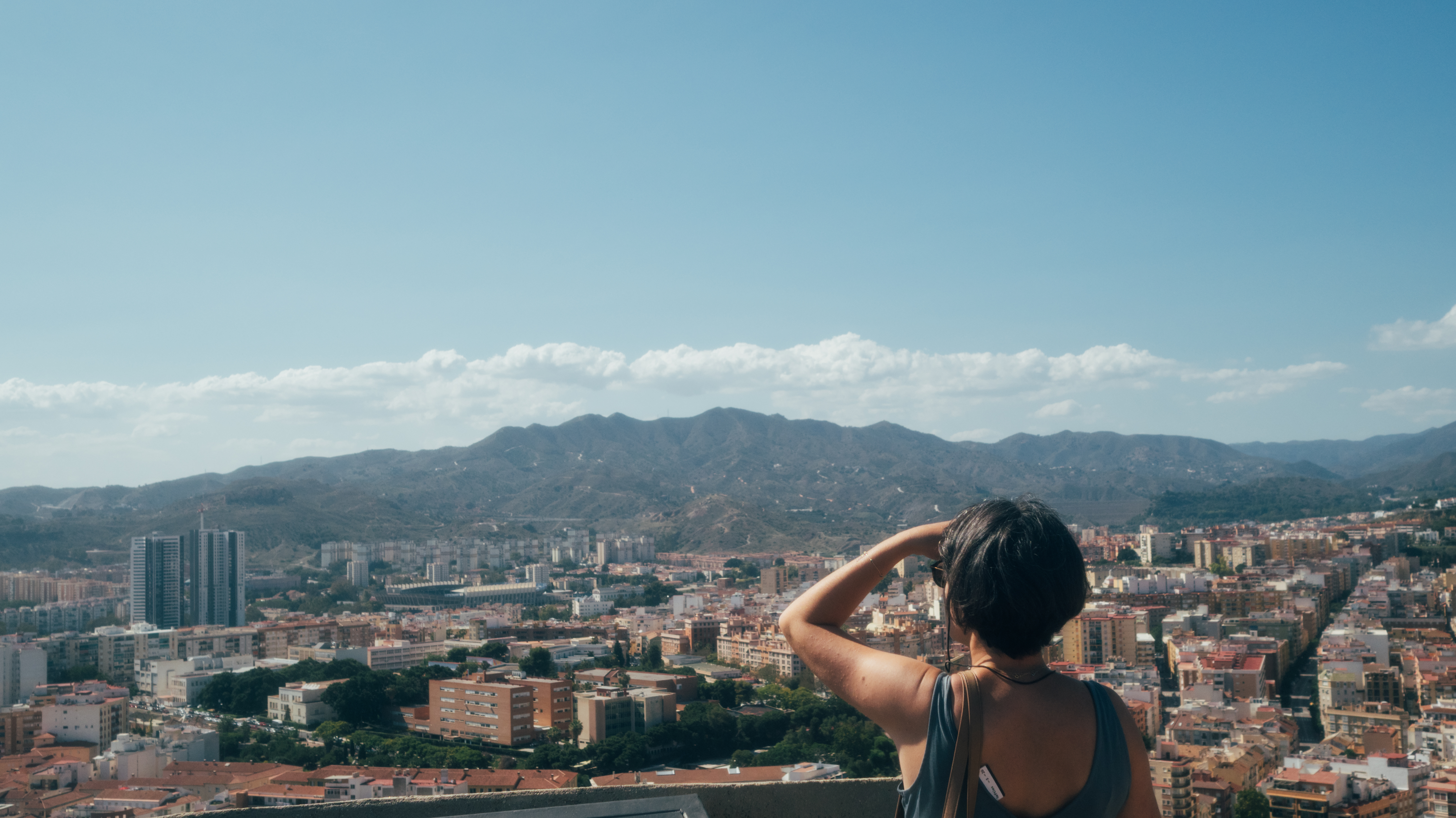 An image of a woman looking out over the city of Malaga in Spain, Olympus EM-5 Mark II sample images