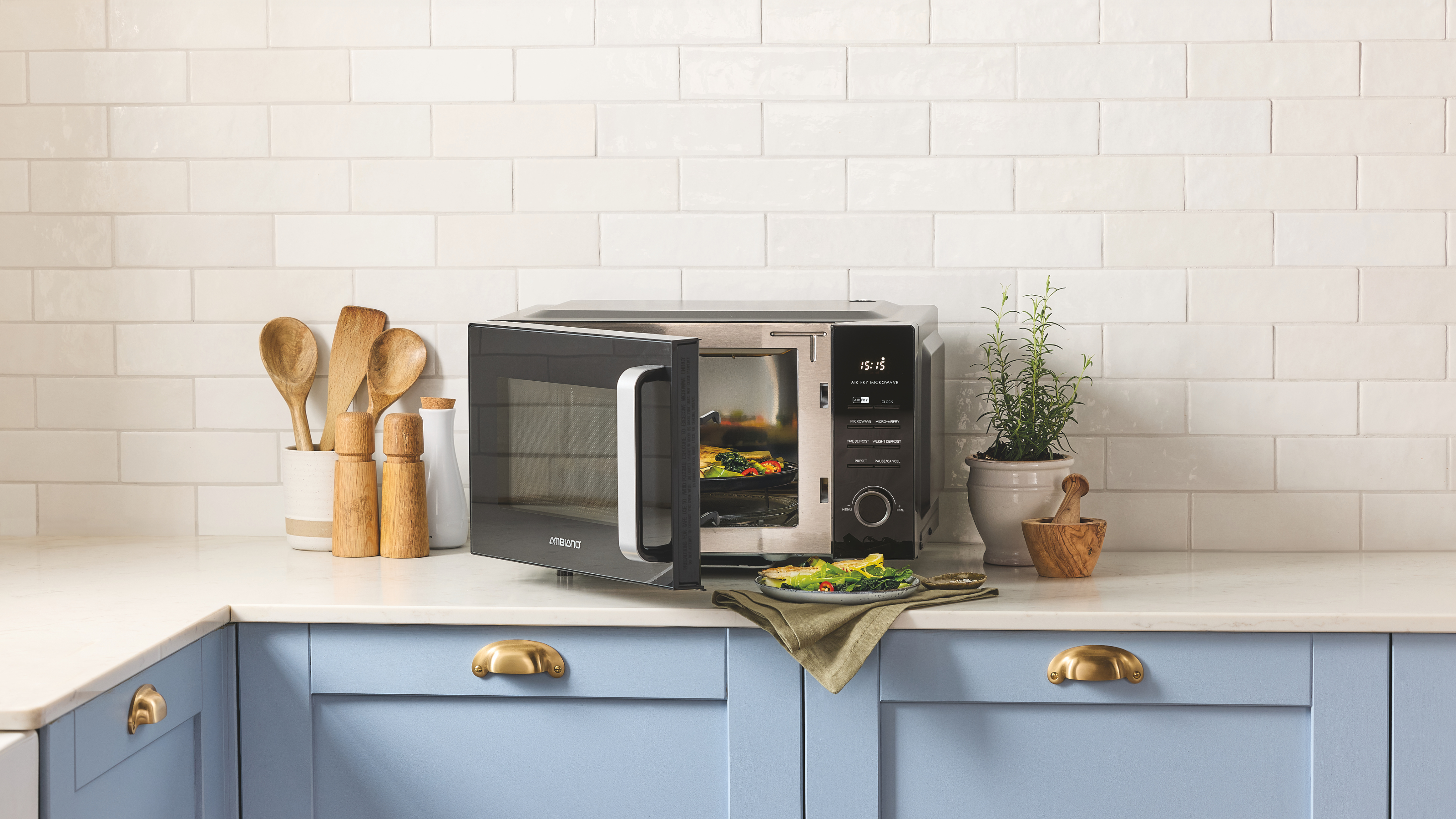 Aldi 2-in-1 Microwave Air Fryer on a white kitchen side with blue cupboards.