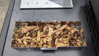 Hickory wood chips in a stainless steel smoker box.