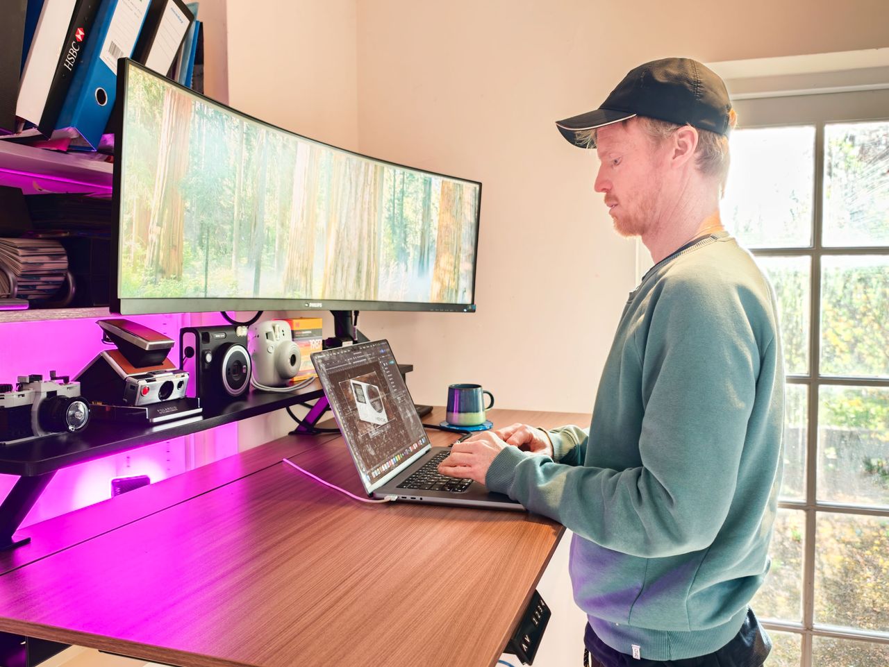 Man stood at the Arozzi Arena Nordico Electric Standing Desk, freshly assembled, in home office room