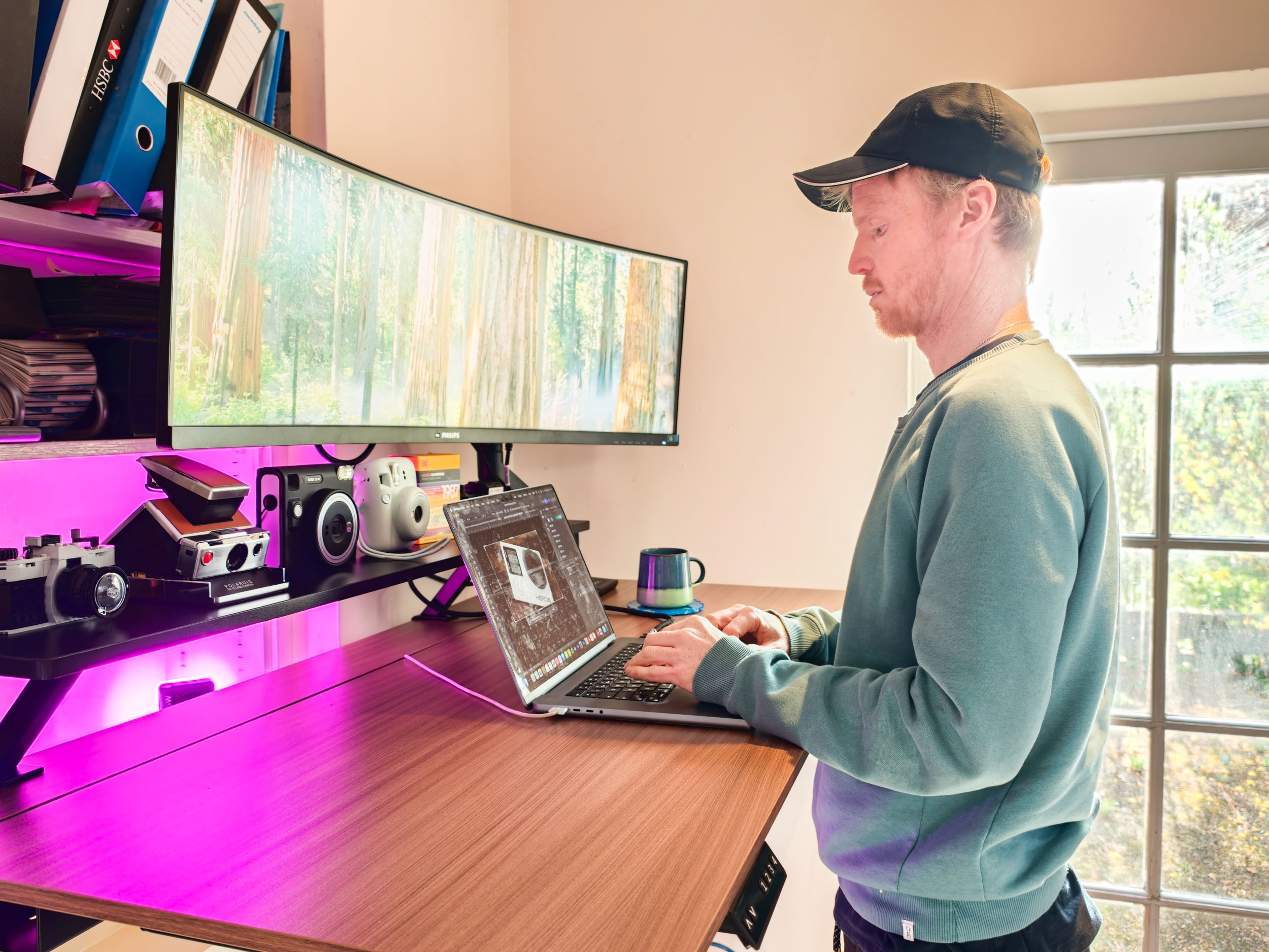 Man stood at the Arozzi Arena Nordico Electric Standing Desk, freshly assembled, in home office room