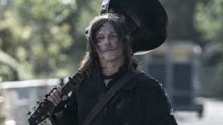 Daryl walking with a guitar propped on his shoulder in The Walking Dead: Daryl Dixon