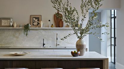 A white marble kitchen with singular open shelf