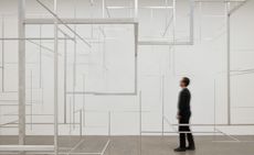 person standing in front of silver grid like structure