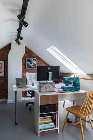 modern office in a loft with white walls, two desks and rooflights