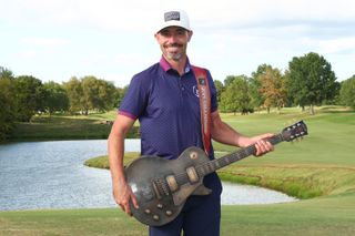 Paul Peterson with the Simmons Bank Open guitar trophy