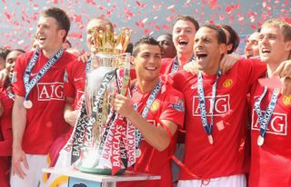 Manchester United players celebrate with the Premier League trophy in May 2009 after winning the competition for a third season in a row.