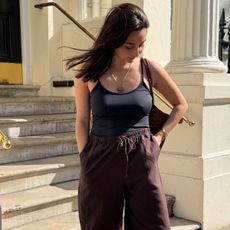 woman wearing black tank top and brown trousers