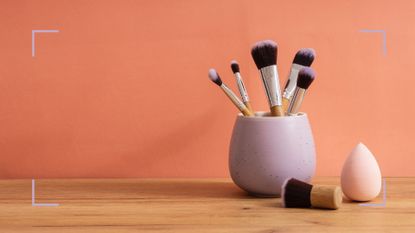 Picture of foundation brush vs sponge on orange background