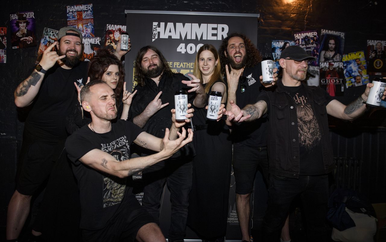 People drinking, smiling and throwing horns at the Metal Hammer 400 party
