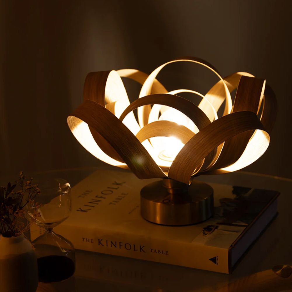 Tom Raffield portable table light on a book in a dark room