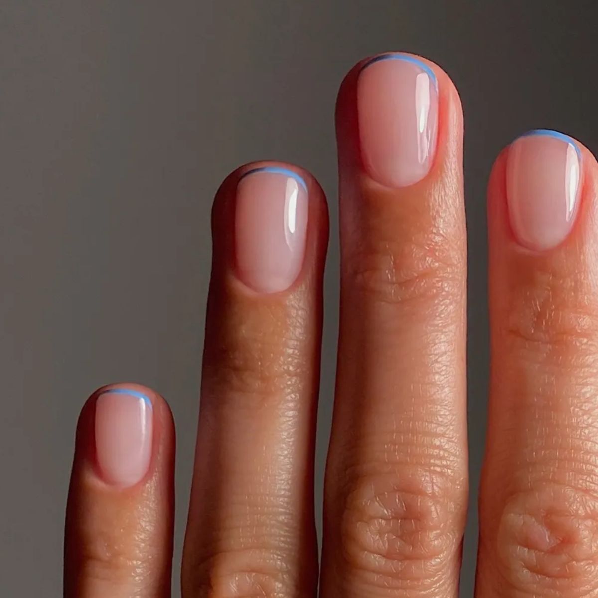 A baby blue French tip manicure