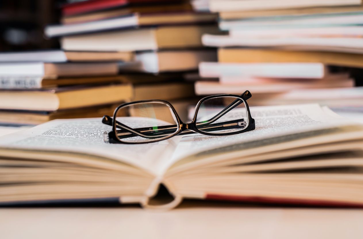 Reading glasses on top of a book.