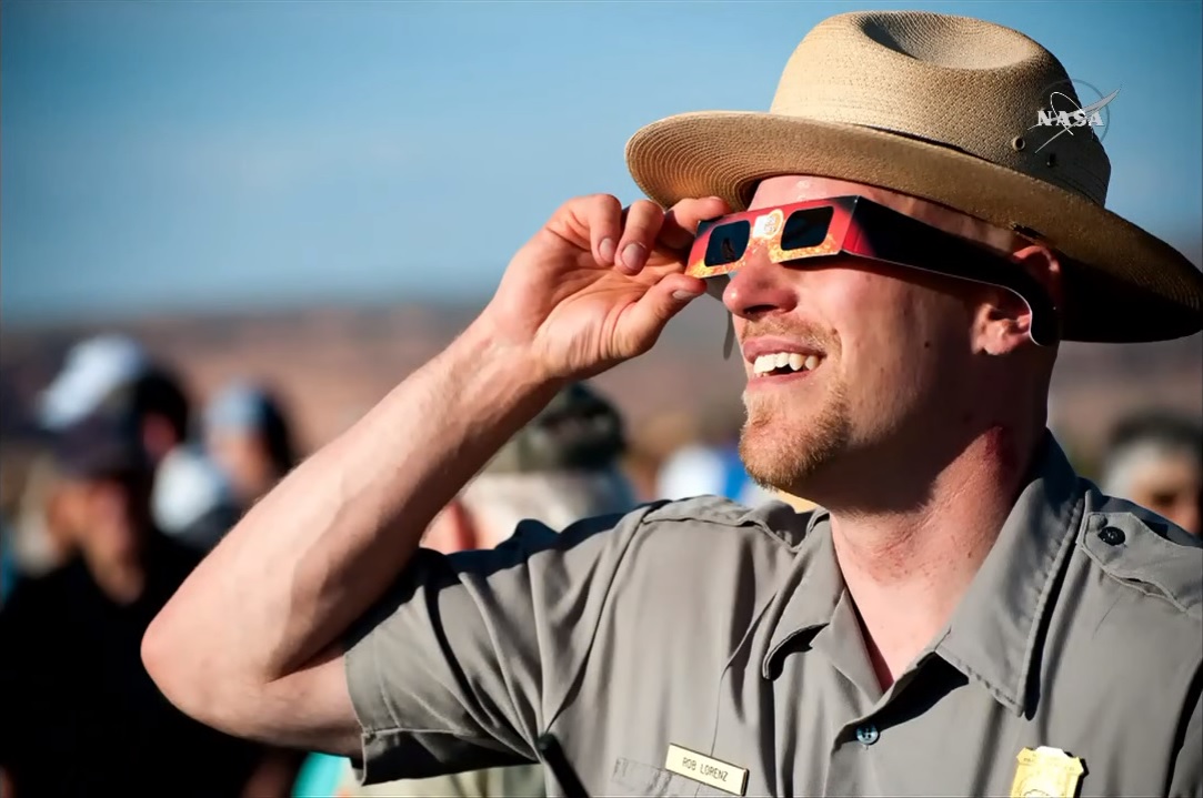 Park officer with solar eclipse glasses